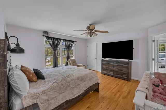 a kitchen with stainless steel appliances granite countertop a refrigerator oven a sink dishwasher and white cabinets with wooden floor