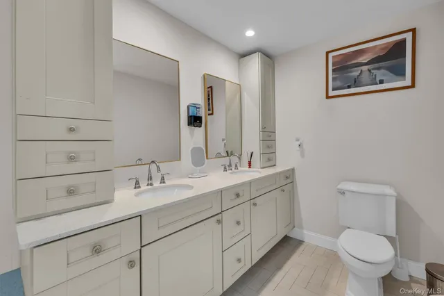 a bedroom with a bed a couch and dresser