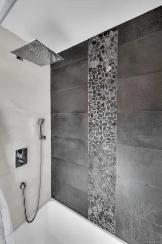 a kitchen with stainless steel appliances kitchen island granite countertop a refrigerator and a stove top oven