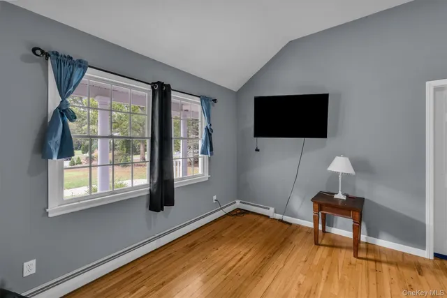 a living room with a flat screen tv and a window