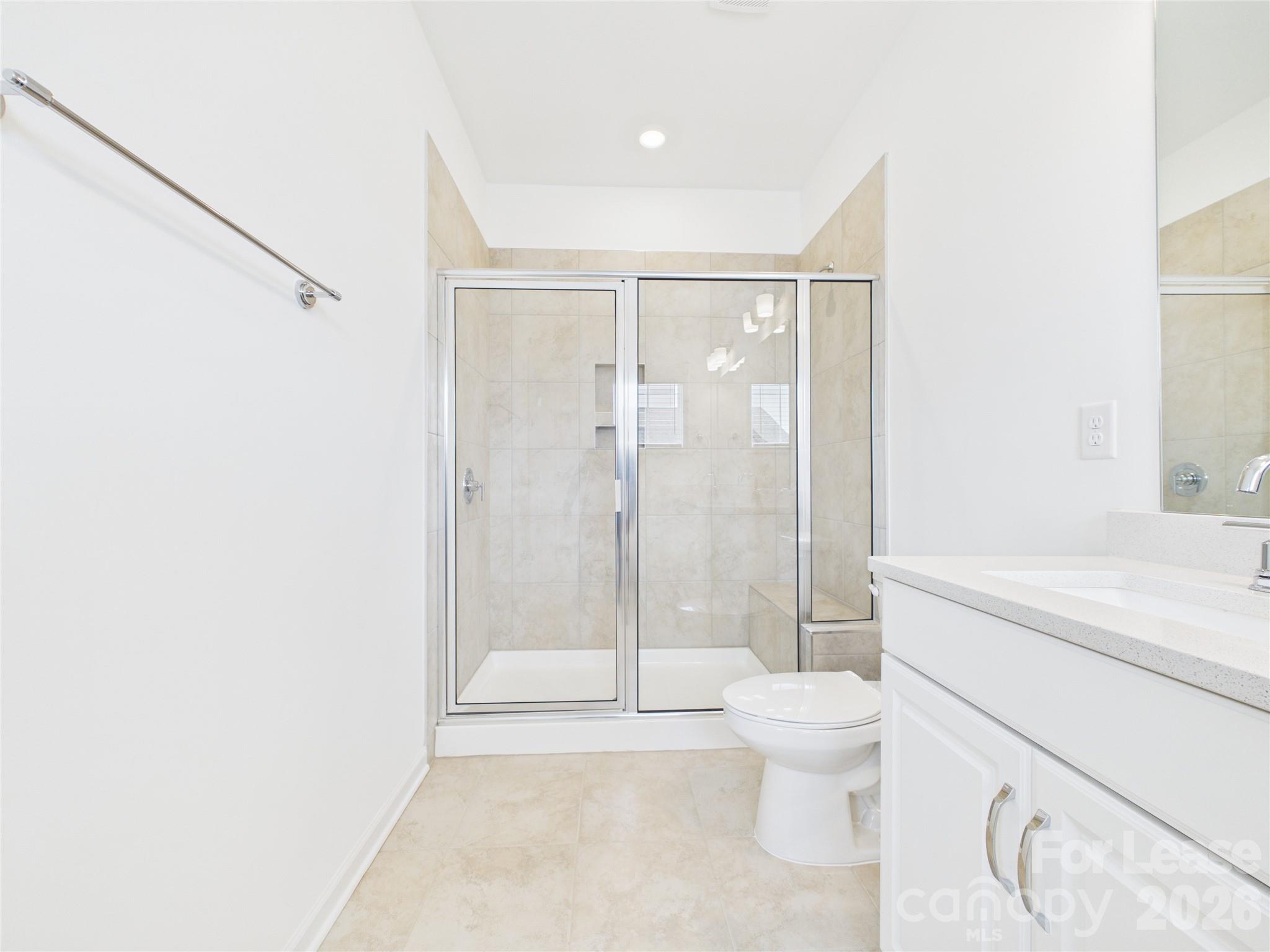 3013 Rexton Lane Charlotte, NC 28262 - Photo 16 of 27 a bathroom with a granite countertop sink a toilet and shower