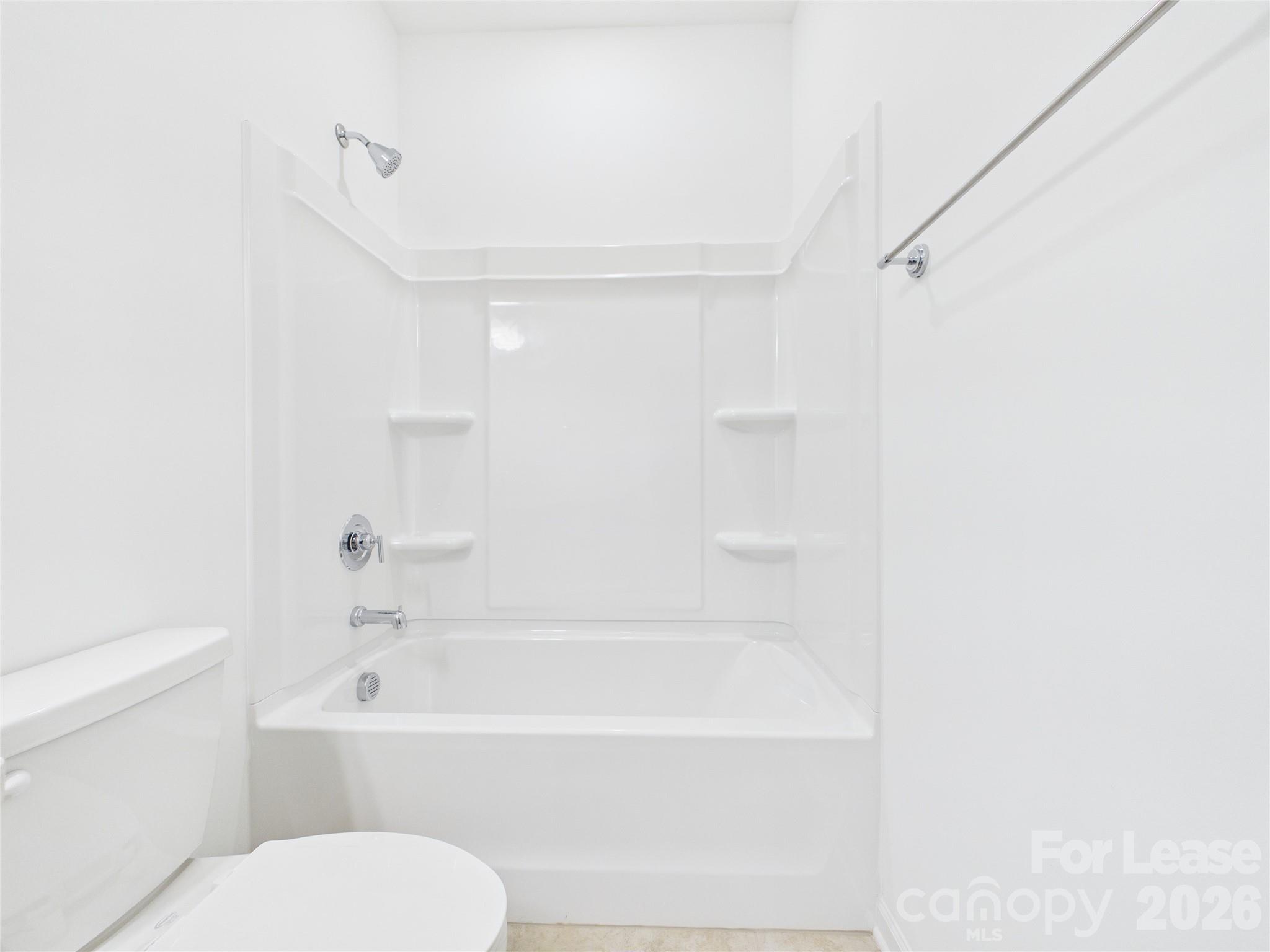 3013 Rexton Lane Charlotte, NC 28262 - Photo 19 of 27 a bathroom with a toilet and a bathtub