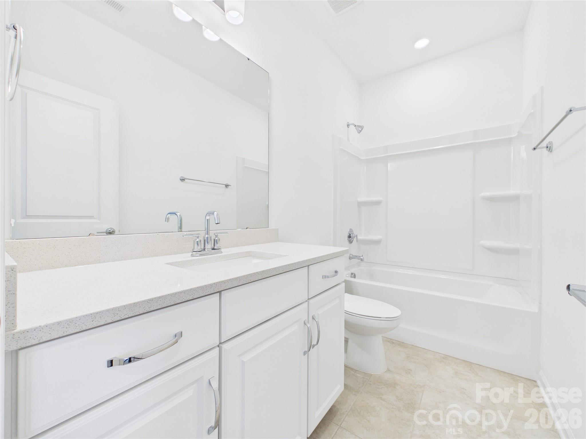 3013 Rexton Lane Charlotte, NC 28262 - Photo 20 of 27 a bathroom with a double vanity sink toilet mirror and bathtub