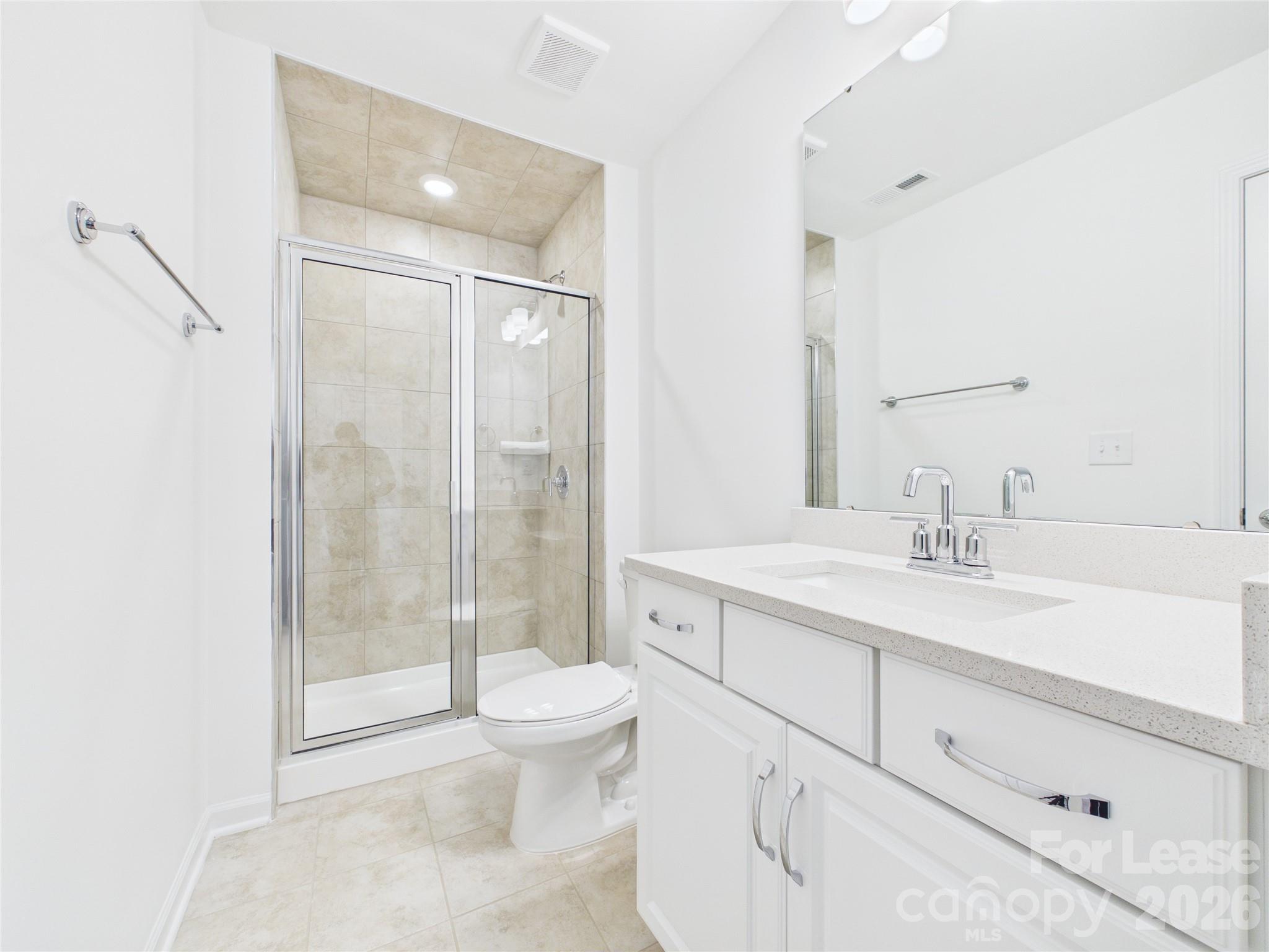 3013 Rexton Lane Charlotte, NC 28262 - Photo 22 of 27 a bathroom with a sink a toilet and shower