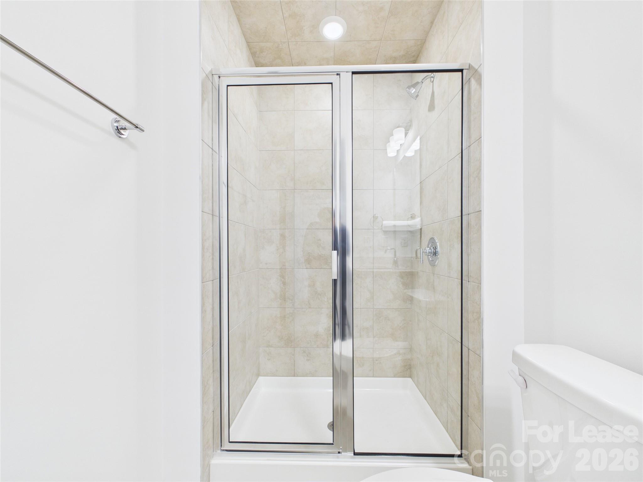 3013 Rexton Lane Charlotte, NC 28262 - Photo 24 of 27 a bathroom with a glass shower door