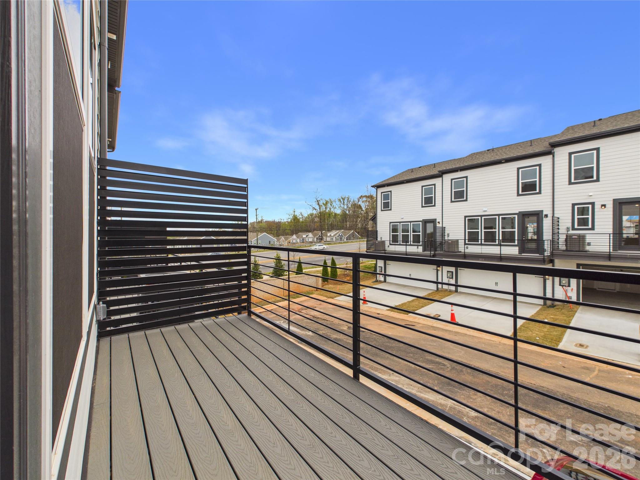 3013 Rexton Lane Charlotte, NC 28262 - Photo 27 of 27 a view of a balcony with floor to ceiling windows with wooden floor