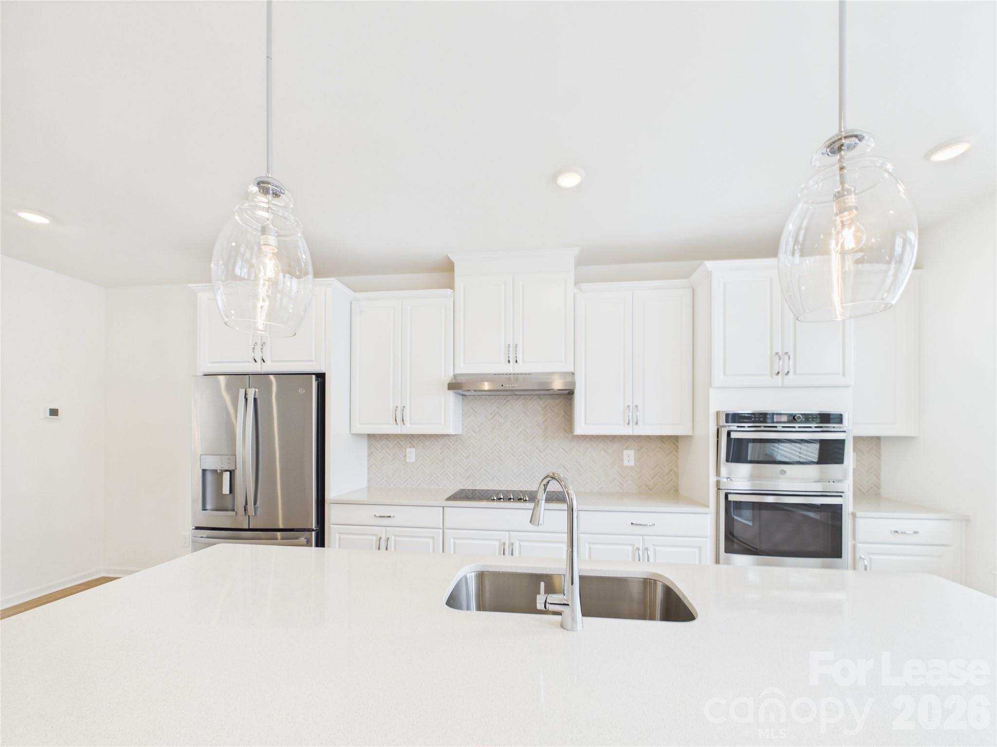 3013 Rexton Lane Charlotte, NC 28262 - Photo 5 of 27 a kitchen with stainless steel appliances granite countertop a sink a stove and a refrigerator