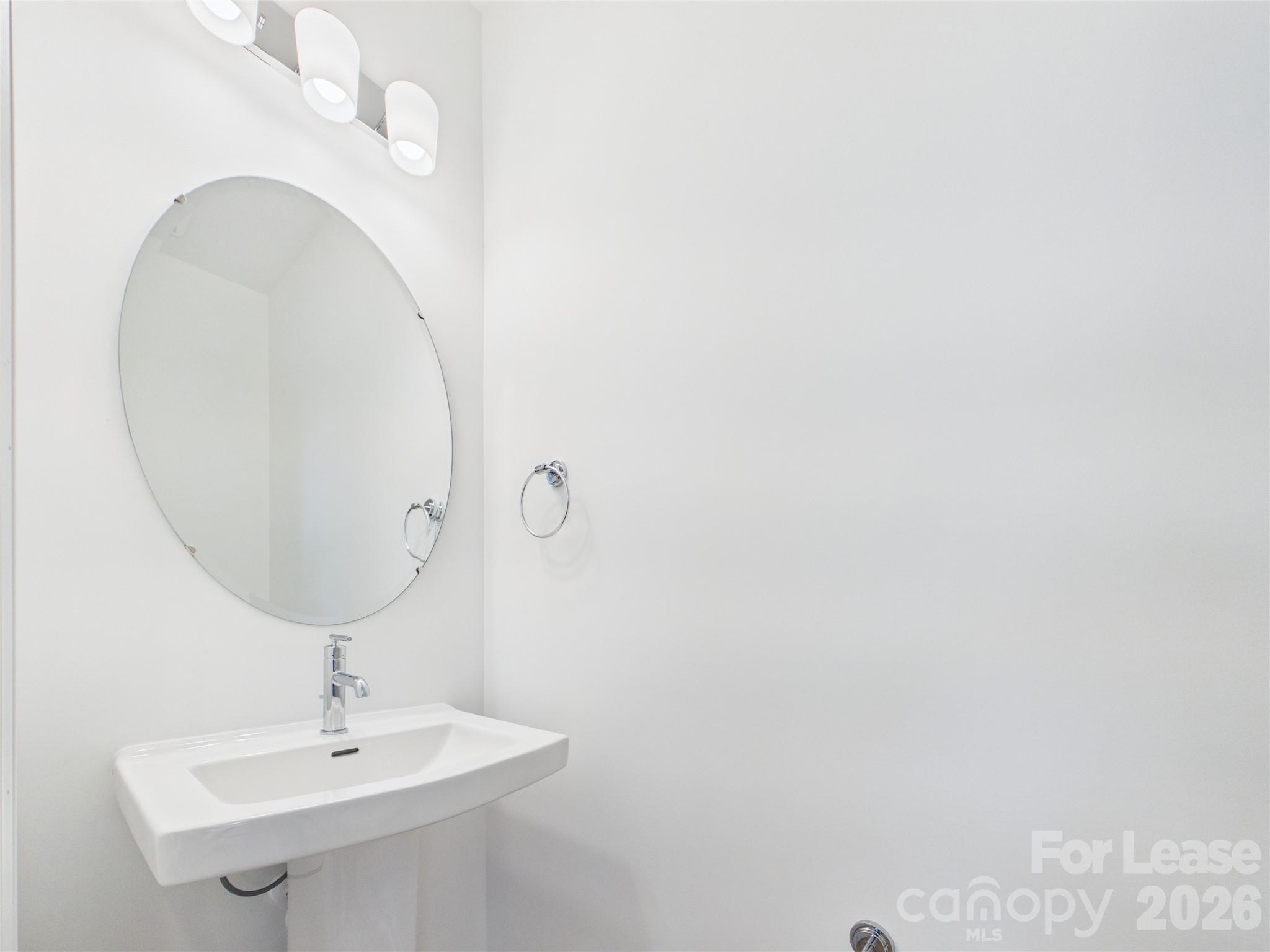 3013 Rexton Lane Charlotte, NC 28262 - Photo 9 of 27 a bathroom with a sink and mirror