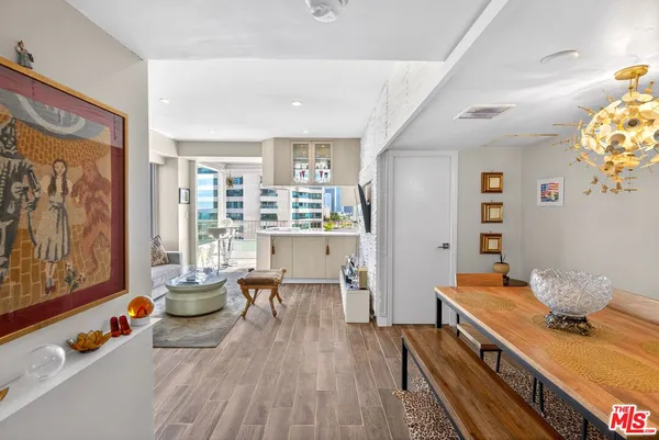 a dining room with furniture and wooden floor