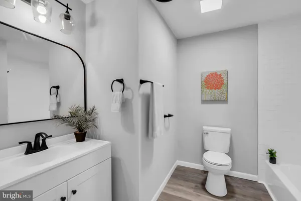 a bathroom with a toilet sink and shower
