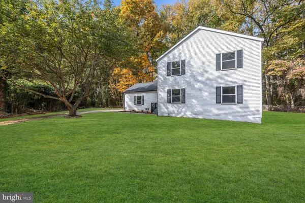 a front view of house with yard and green space