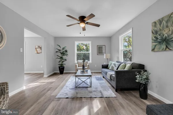 a living room with furniture and wooden floor