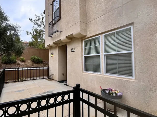 a view of a patio with a table and chairs
