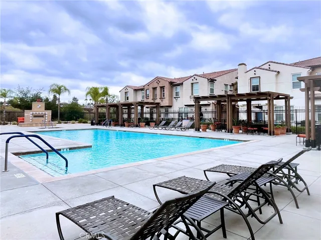 a view of a swimming pool with outdoor seating