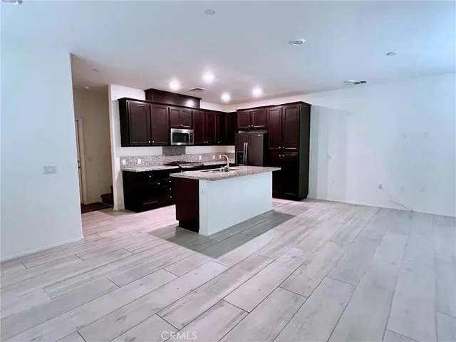 a kitchen with stainless steel appliances a sink and refrigerator