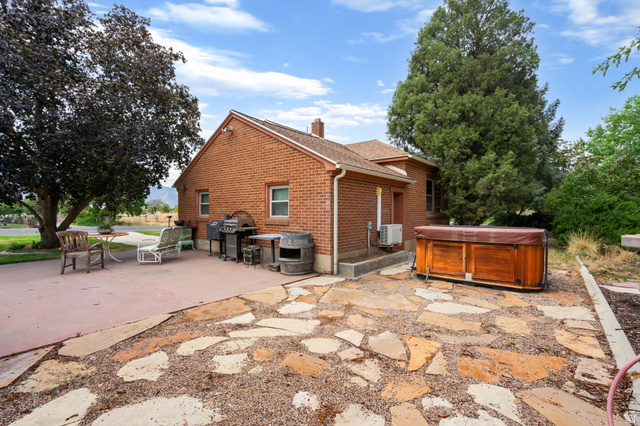 615 East Maple Street Mapleton, UT 84664 - Photo 27 of 30 Red brick exterior with white trim windows and a prominent chimney