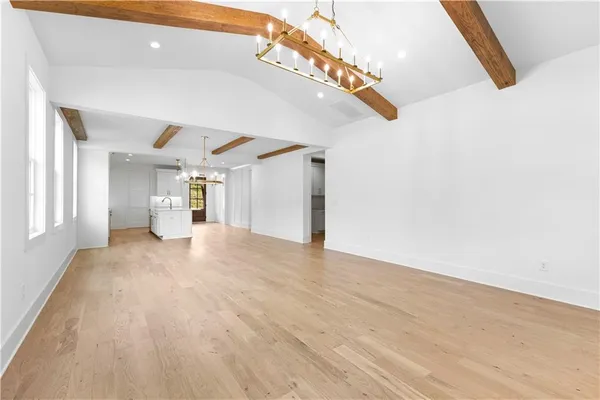 a view of empty room with fireplace and wooden floor