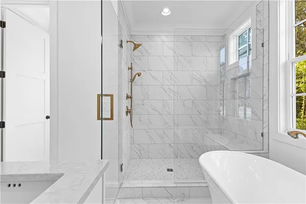 a bathroom with a granite countertop sink and large window