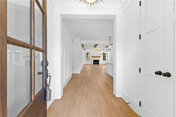 a view of a hallway with wooden floor and staircase
