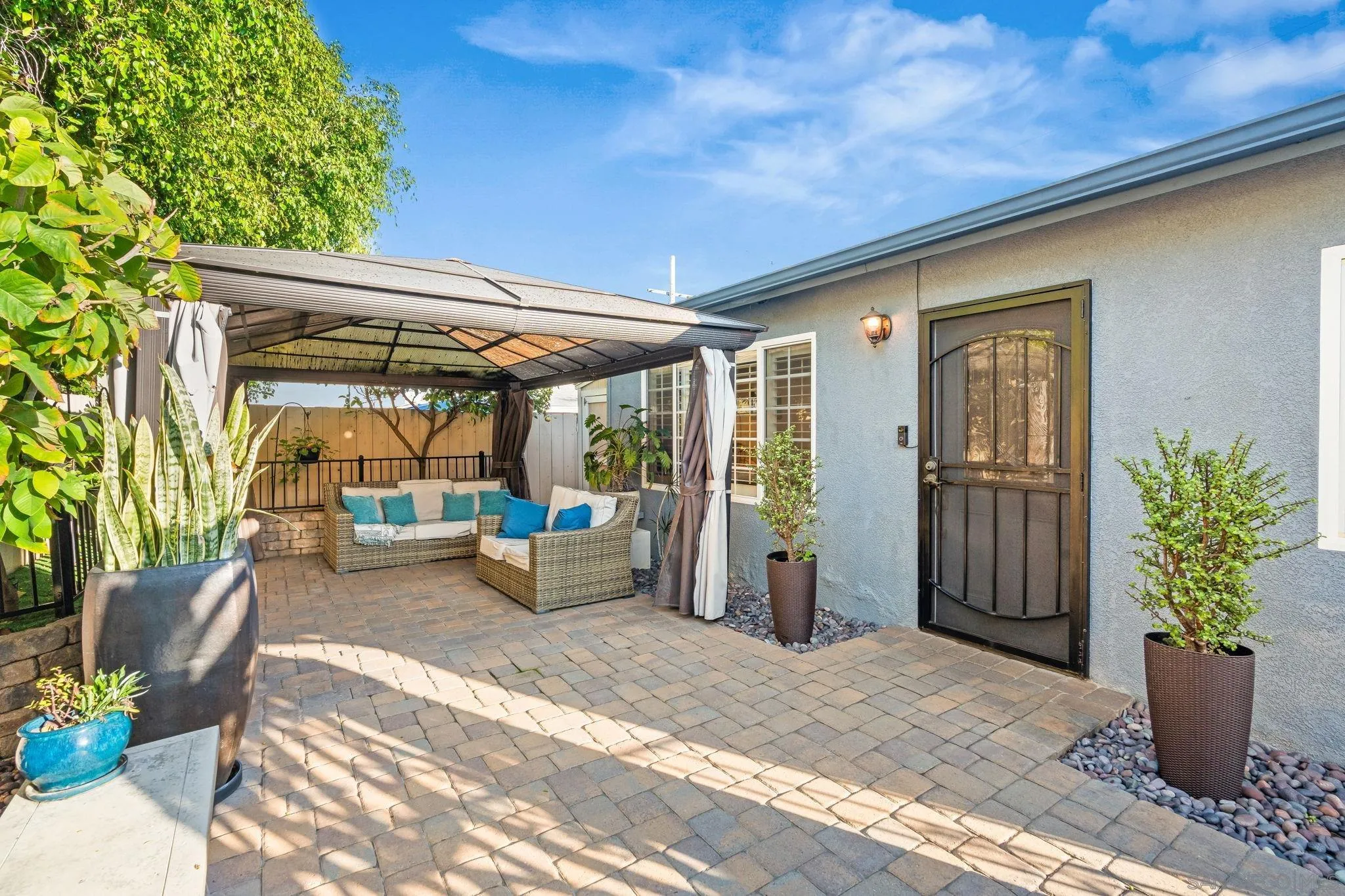 a view of a patio with table and chairs and potted plants