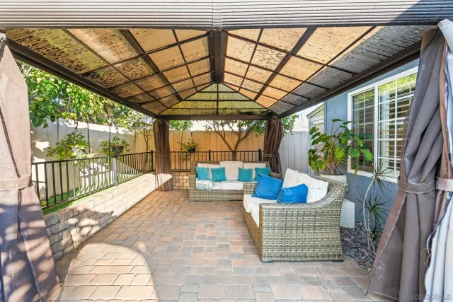 a balcony with furniture and a potted plant