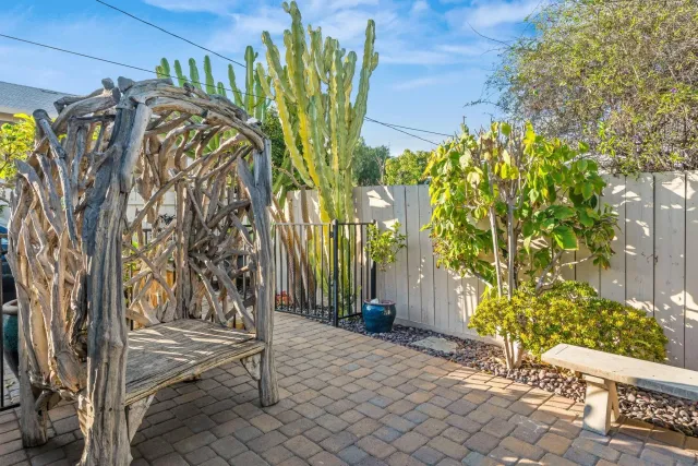 a view of a house with a tree and flower plants
