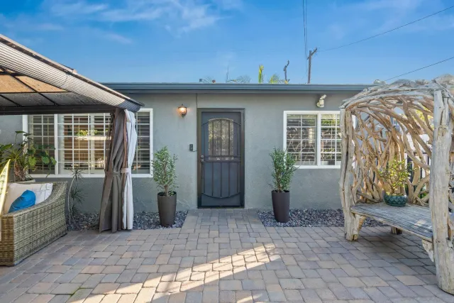 a view of a porch with furniture and floor to ceiling window