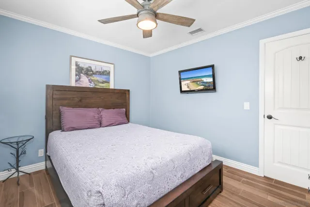 a bedroom with a bed and a chandelier