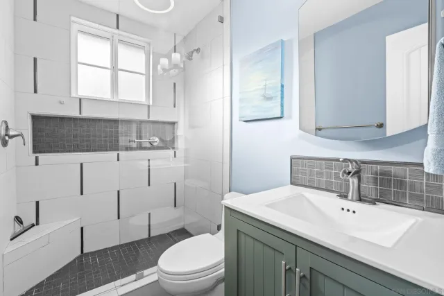 a bathroom with a sink a toilet and vanity