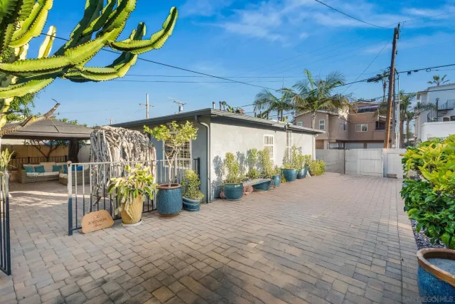 a view of a patio with a table and chairs under an umbrella