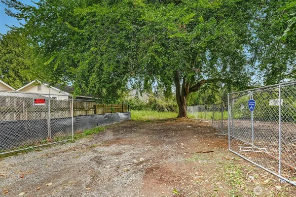 a view of a backyard with fence