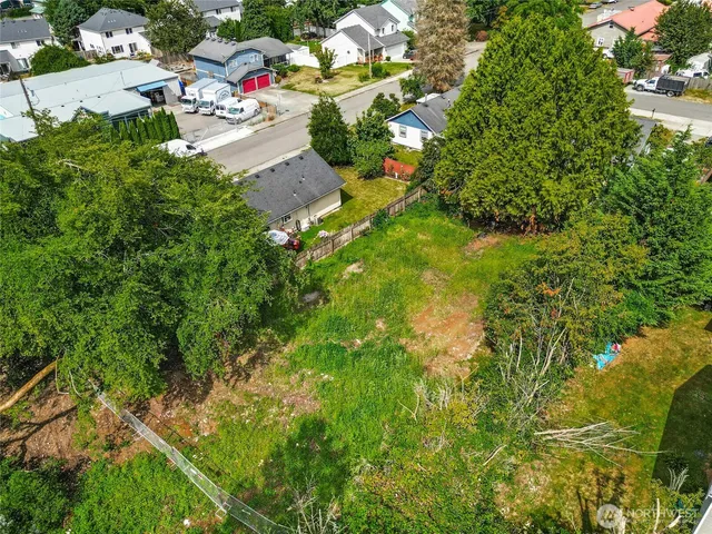 a view of aerial view of residential houses with yard and swimming pool