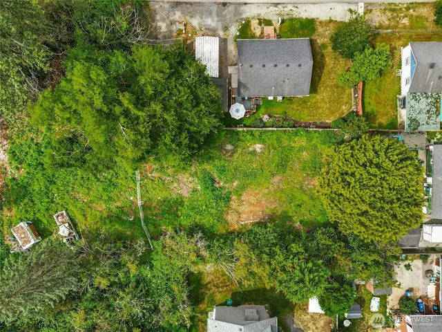 an aerial view of a house with a yard and garden