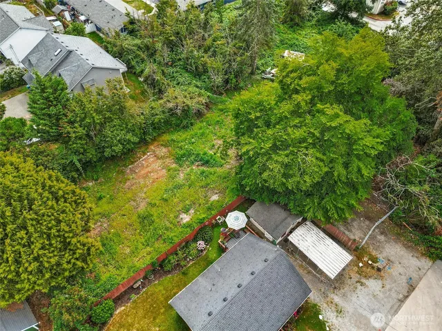 an aerial view of a house with a yard