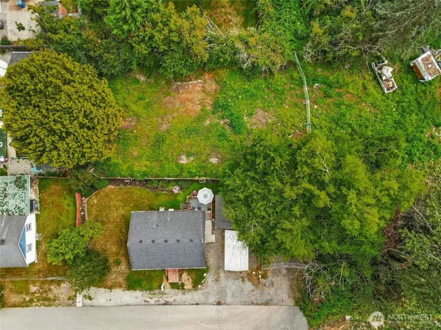 an aerial view of a house with a yard basket ball court and outdoor seating