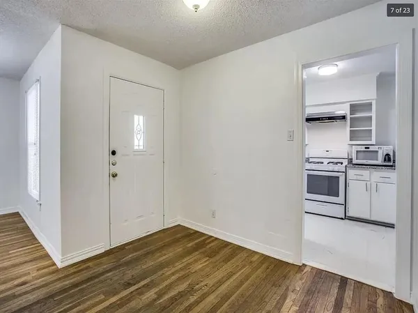 a view of kitchen with wooden floor and electronic appliances