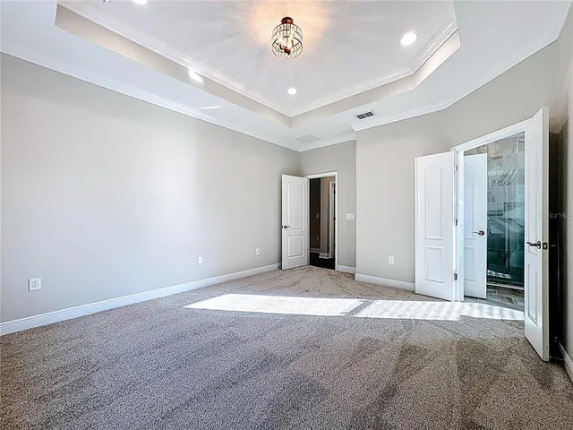 a view of a room with wooden floor potted plant and a chandelier