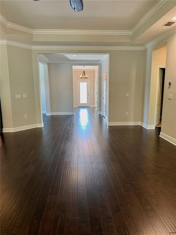 2894 Sand Oak Loop Apopka, FL 32712 - Photo 32 of 69 a view of an empty room with wooden floor and a window