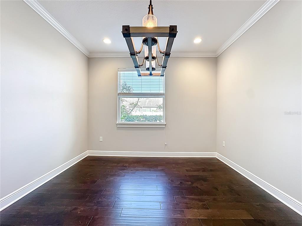 2894 Sand Oak Loop Apopka, FL 32712 - Photo 39 of 69 a view of a room with wooden floor potted plant and a chandelier