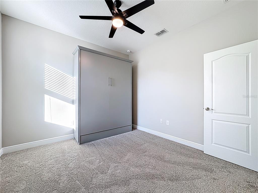 2894 Sand Oak Loop Apopka, FL 32712 - Photo 43 of 69 an empty room with windows and fan