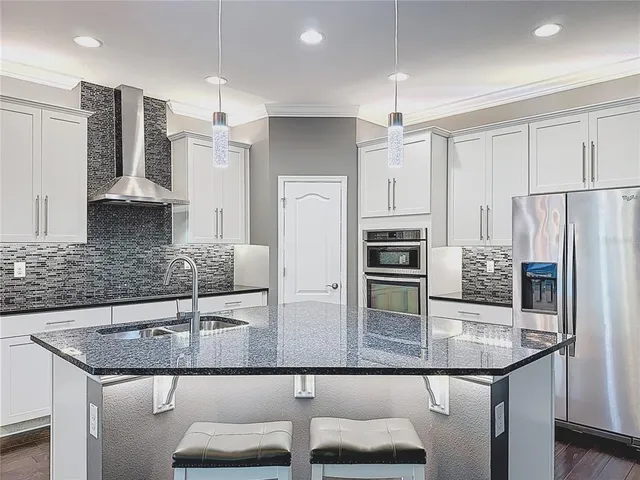 a front view of a house with a yard and tree