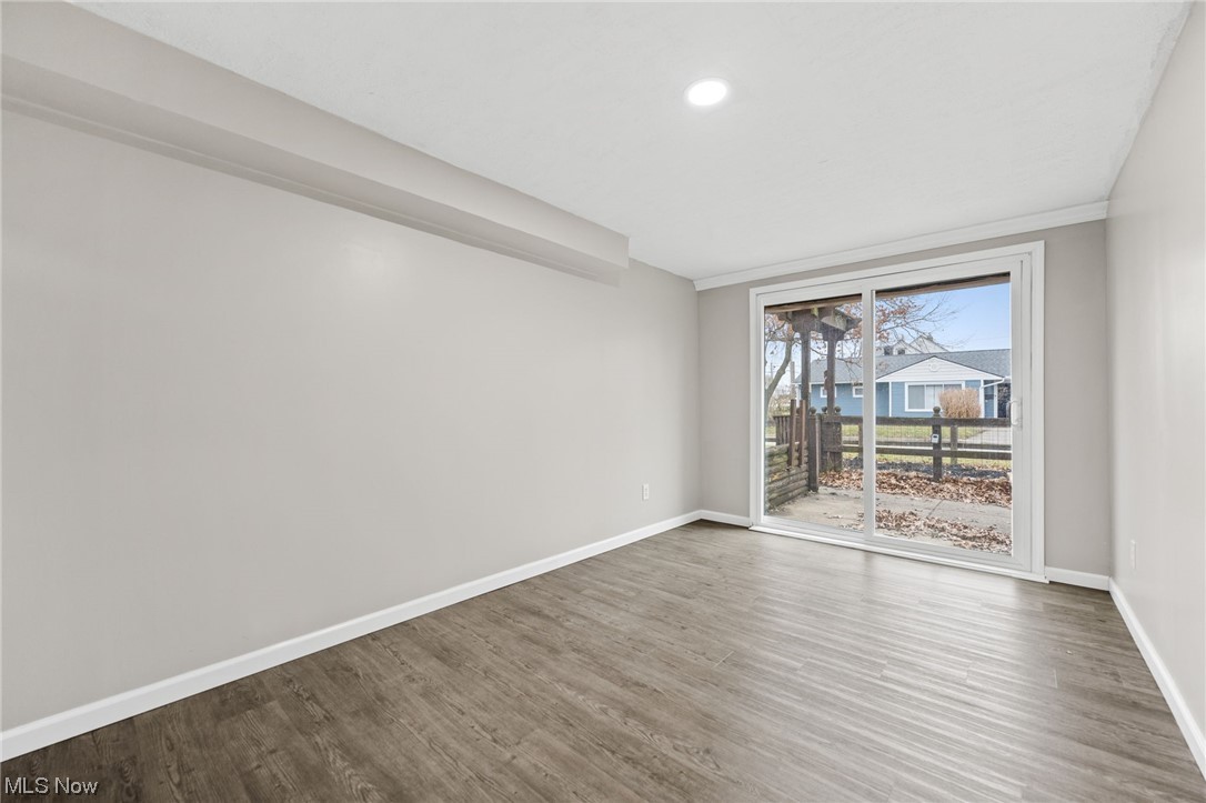 11417 Snow Road Parma Heights, OH 44130 - Photo 27 of 32 bedroom featuring vinyl floors and sliding glass door.