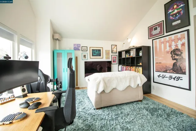 a bed sitting in a bedroom next to a window with books on it