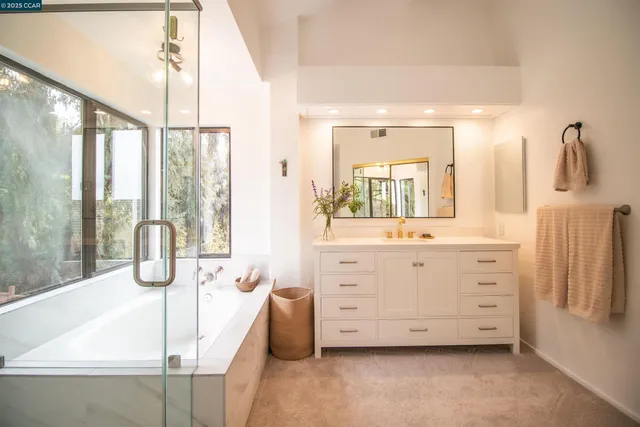 a spacious bathroom with a double vanity sink and mirror