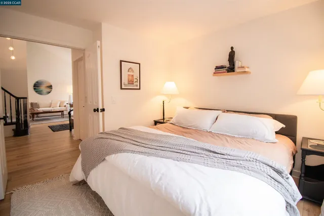 a bedroom with a bed and a chandelier