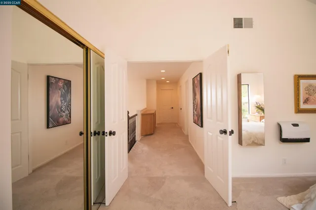 a hallway with sliding door and bedroom view