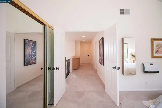 a spacious bathroom with a double vanity sink a mirror a and a shower
