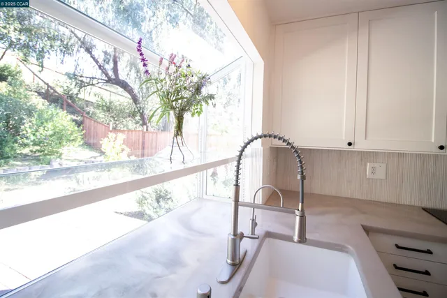 a kitchen with granite countertop a stove a sink and a microwave