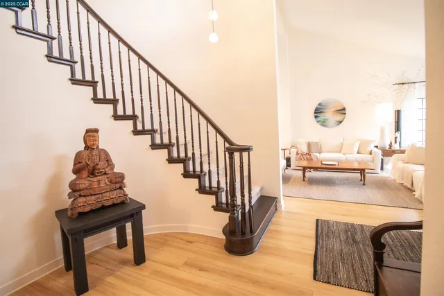 a view of entryway and hall with wooden floor
