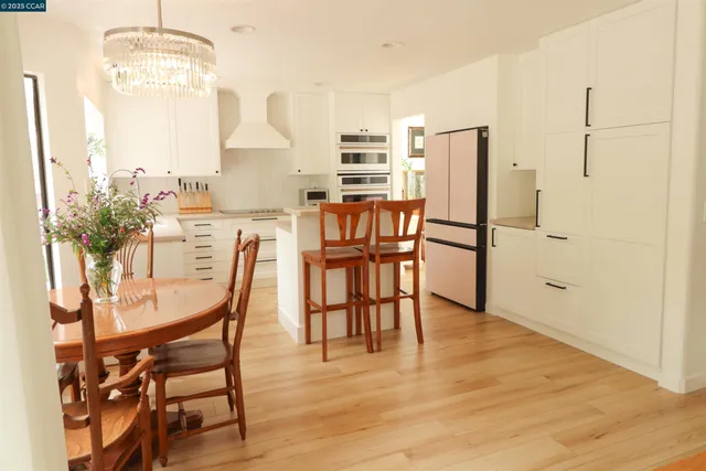 a dining room with furniture and wooden floor